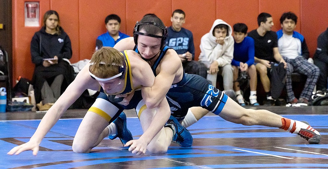 Senior captain Eduar Polanco works for a bar finish in the Bernie Miller Invitational in Rye on Saturday, Dec. 14. He won the Port Chester Rams’ Most Outstanding Wrestler award after going 5-0 with five pins. He is 10-1 on the season and has a career record of 68-22.