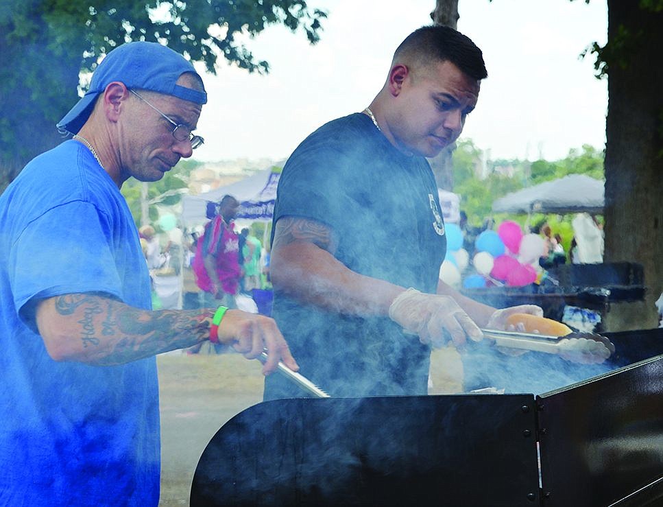  Co-owner Frank Blasi and his employees  from Cousin Frankie's USA Grill in Port Chester cook up burgers and hotdogs at Unity Day at Columbus Park on Saturday, Aug. 9. 