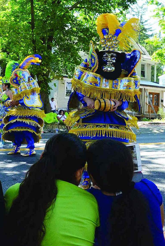 Parade-goers watch the performers from Fraternidad Morenada Central of Port Chester.