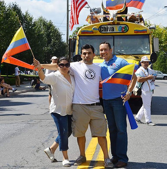 Isabel Astudilo, Marlon Lopez and Alex Payan from the Latino  Network march in the parade.
