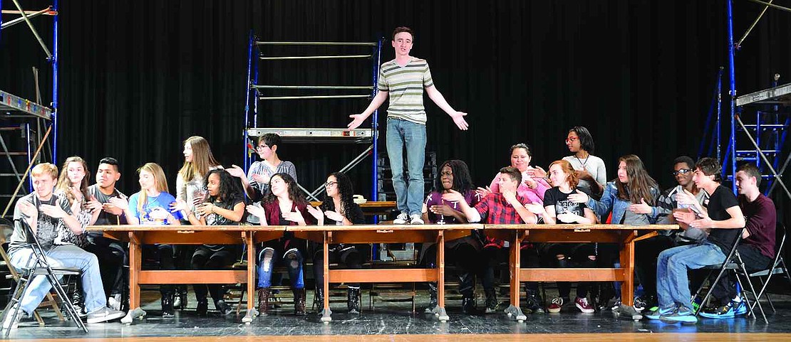  Port Chester High School junior Liam Herbert, as Mark from Rent, stands on a table during the song with the same name as the musical. Herbert was nominated for a Metropolitan High School Theater Award for male acting performance.  