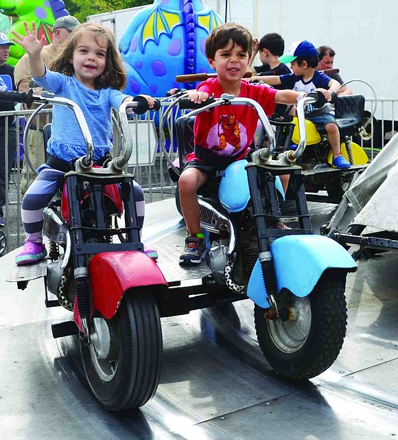  Marco Spinelli (right), a 3-year-old from Barrett Lane, and his cousin, 2-year-old Cammy Pino from Southport, Conn., cheerfully ride their motorcycles round in circles. 