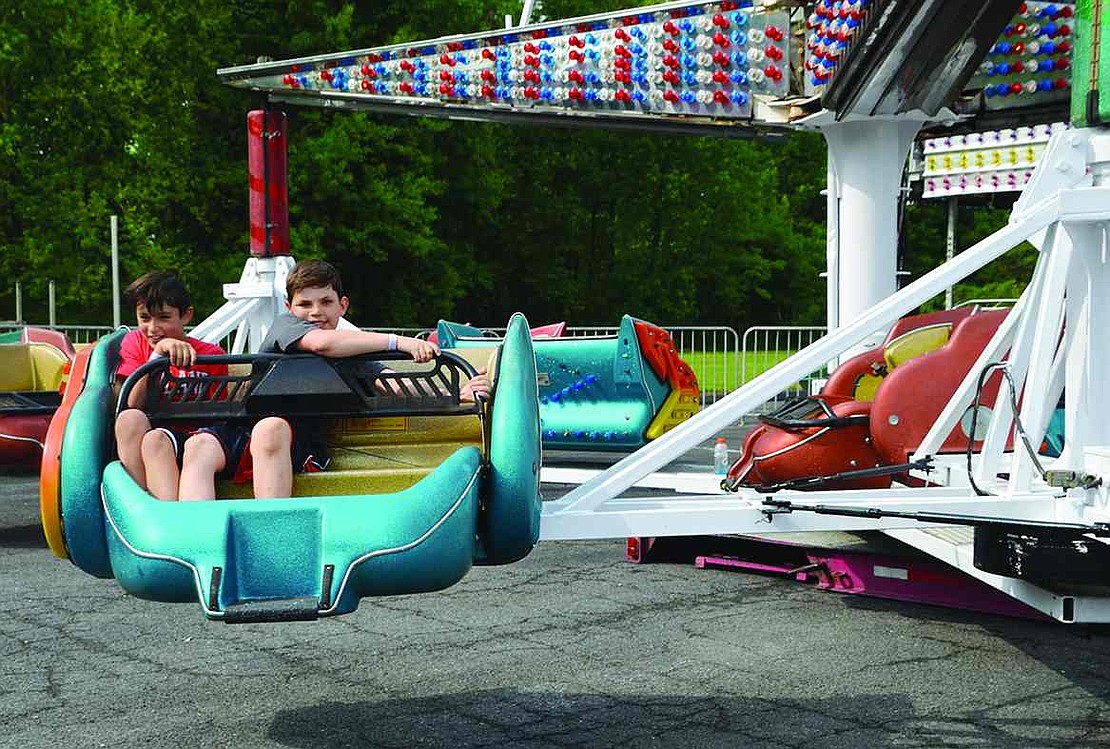  Rye Brook 11-year-olds Josh Kaminsky (left) and Daniel Sosa hang on tight as they are twirled through the air.