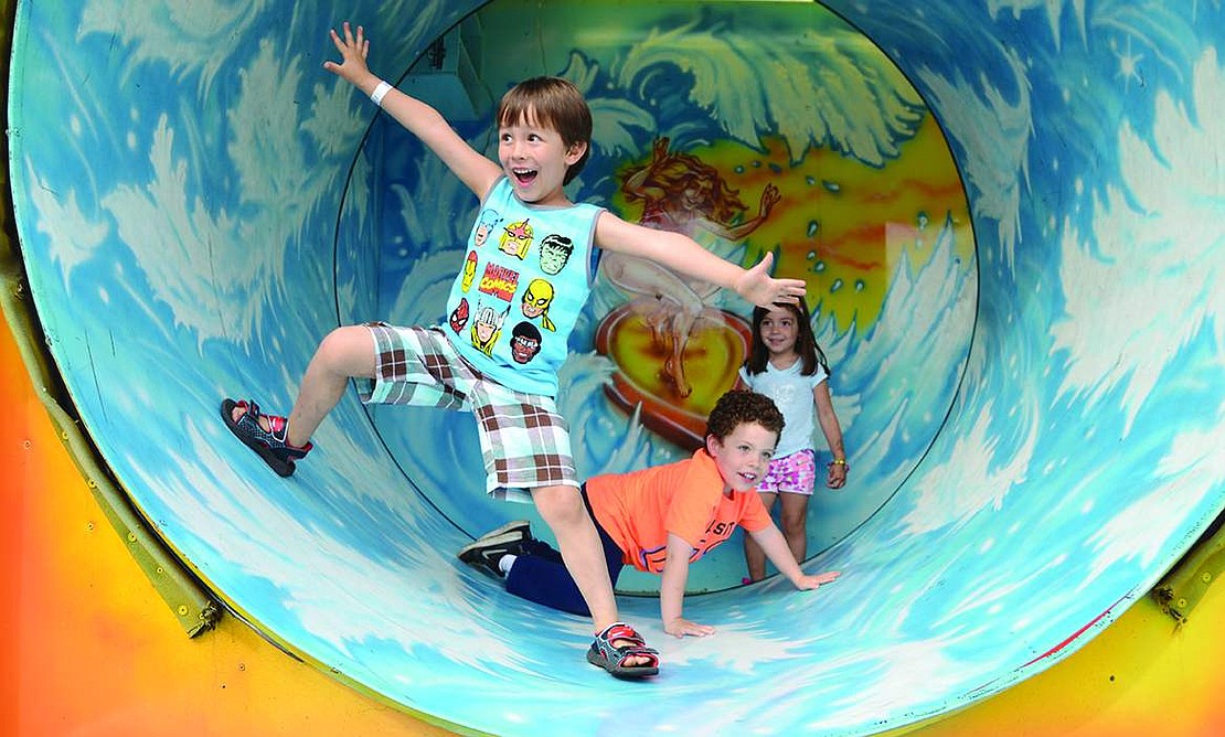  Felipe Xavier of Rye carefully keeps his balance despite the twisting tunnel in one of the rides at the carnival.