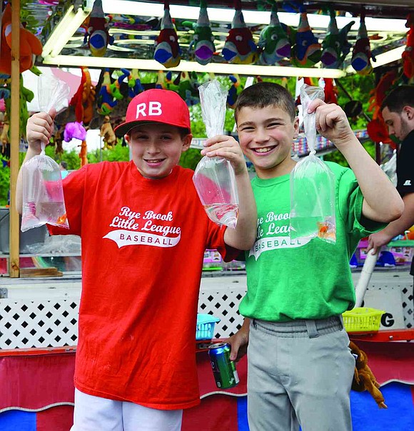  Rye Brook baseball players AJ Wilk (left), 10, and Ben Berk, 11, take a break from the diamond to win some goldfish at one of the many midway games set up on Saturday afternoon, May 16. The third annual Rye Brook carnival, set up in the parking lot at 900 King St., ran Friday, May 15 through Sunday, May 17.