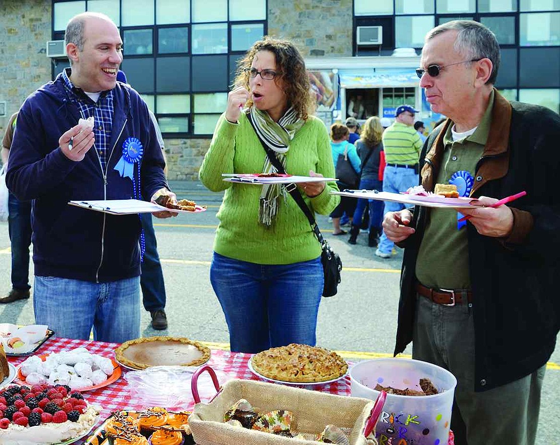 Acting as judges in the bake-off, Board of Education President Jeff Diamond (left), Ridge Street School Principal Tracey Taylor and Blind Brook Superintendent William Stark sample their way through 18 submitted desserts. 