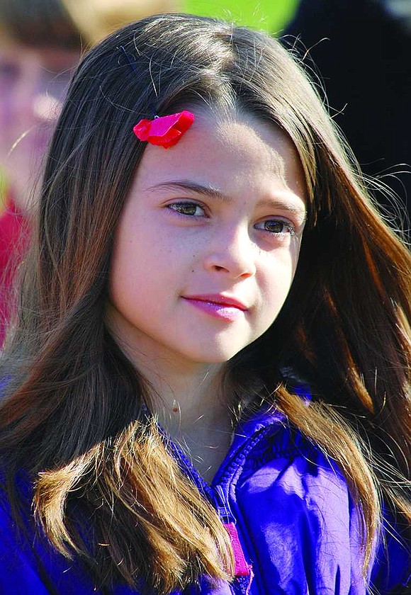  King Street School 4th grader Sophia Quartarolo sports a red poppy in her hair, one of 500 made by parent Naoka Russo for children, staff and veterans in recognition of the 100th anniversary of the end of World War I which is being celebrated this year.