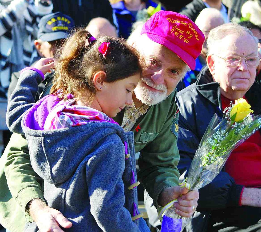  In their 10th year honoring veterans at this time of year, King Street School students presented yellow roses to 40 men who have served our country in the armed services and recognized another 35 who are deceased or were unable to attend. Here kindergartner Marisa Rachiele gives a flower to her grandpa, Vietnam veteran Tom Colacioppo of the Bronx. 