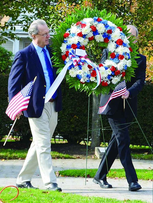  Rye Town Supervisor Joe Carvin and Port Chester Deputy Mayor Gene Ceccarelli carry a memorial wreath to place in front of the central monument at the Port Chester-Rye Brook Veterans Day Ceremony at Veterans' Memorial Park on Sunday, Nov. 10.
