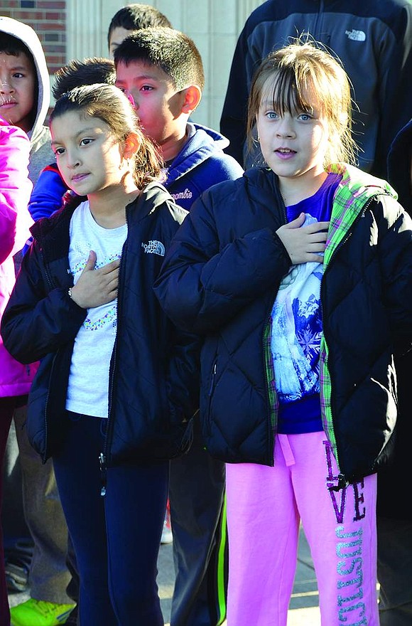  Hands over their hearts, Park Avenue School fourth graders Olga Carcamo and Sophia Gonzalez sing "God Bless America."