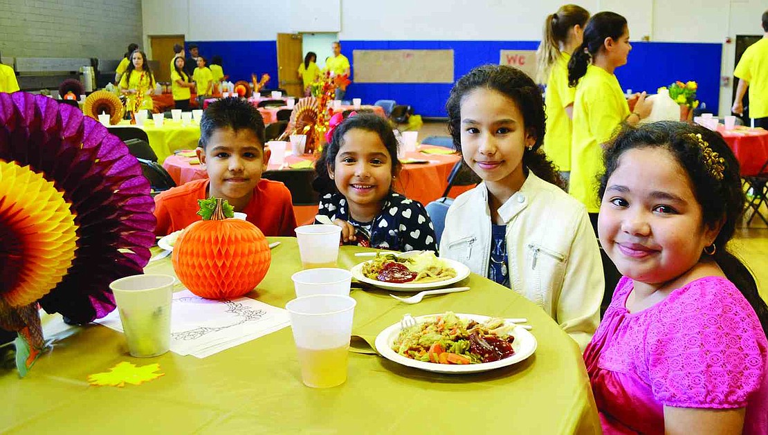  Children enjoy a monster-sized Thanksgiving-themed feast at The Carver Center in Port Chester prepared by Chef Gustavo Diaz before receiving coats from The Children's Hope Chest, a non-profit in Purchase that encourages children to help other children. Volunteers from Hope Chest gave 300 brand new coats along with hats and gloves to Carver children during two dinner seatings on Sunday, Nov. 23. 