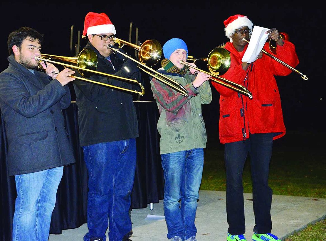 Four Port Chester High School Brass Ensemble members perform holiday songs. 