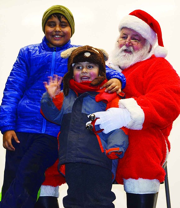 Ten-year-old Kevin Guman of Maple Place and his little brother, Michael, 3, meet Santa, played by George Vigue of New Rochelle. 