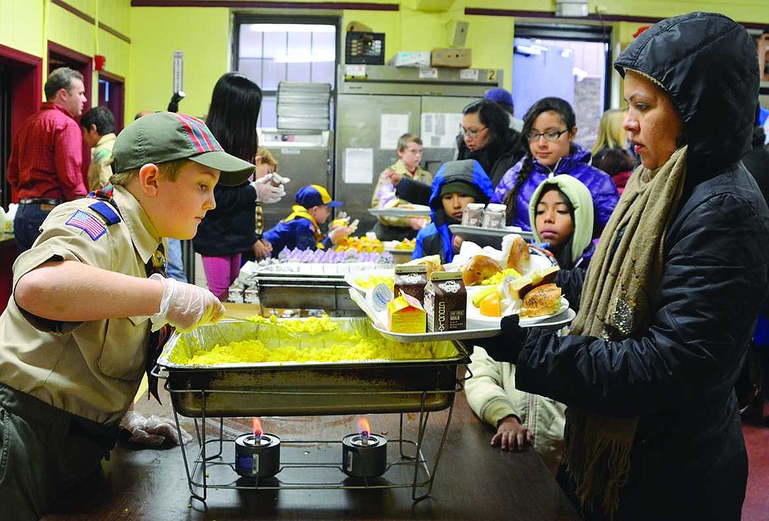 James Donovan, a 10-year-old from Rye, dishes out some eggs in the kitchen. Donovan's Cub Scout Pack 35 from Greenwich, Conn. made breakfast and then served it up for the hundreds that passed through Don Bosco Center that Saturday morning. 