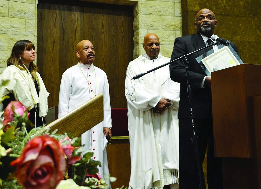 David Thomas, a Port Chester resident who helped restore Rye Town's neglected African American cemetery in Rye, holds the 2015 humanitarian award as Rabbi Jaymee Alpert, Bishop  Robert Girtman and Rev. Gerald Washington stand behind him. 