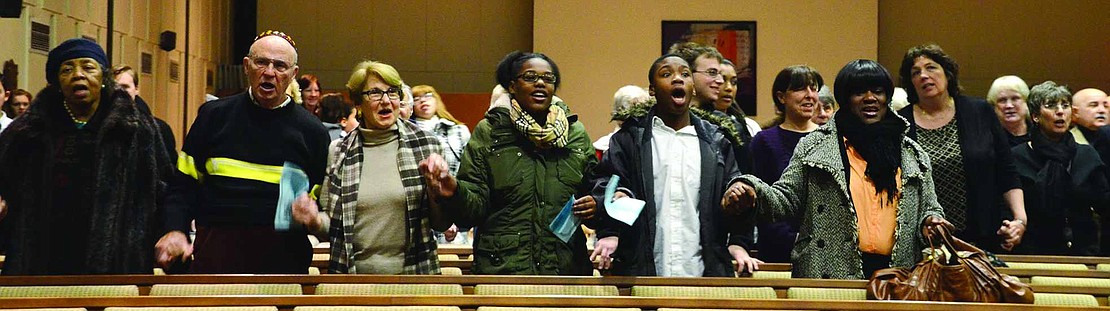 Jews and Christians, whites and blacks, hold hands as they sing together at the end of the interfaith commemoration of the life of Dr. Martin Luther King, Jr. 