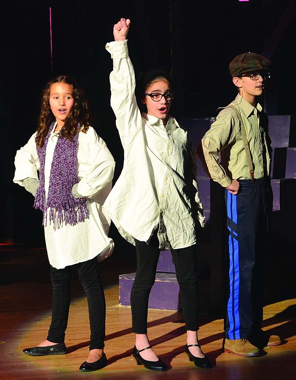  A trio of friends, played by 6th grader Anna Leland (left), 6th grader Alyssa Bucci and 7th grader Ryan Egan, sing about their love of candy. 