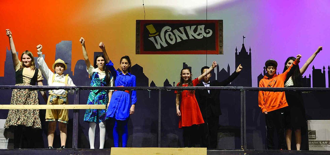  The finders of the golden tickets hold them up high above their heads. From left: Kate Jaffee, Sam Knee, Rachel Harris, Kayla Axelrod, Dean Moschitto, Olivia Lombardi, Wyatt Steinthal and Victoria Nioras. 