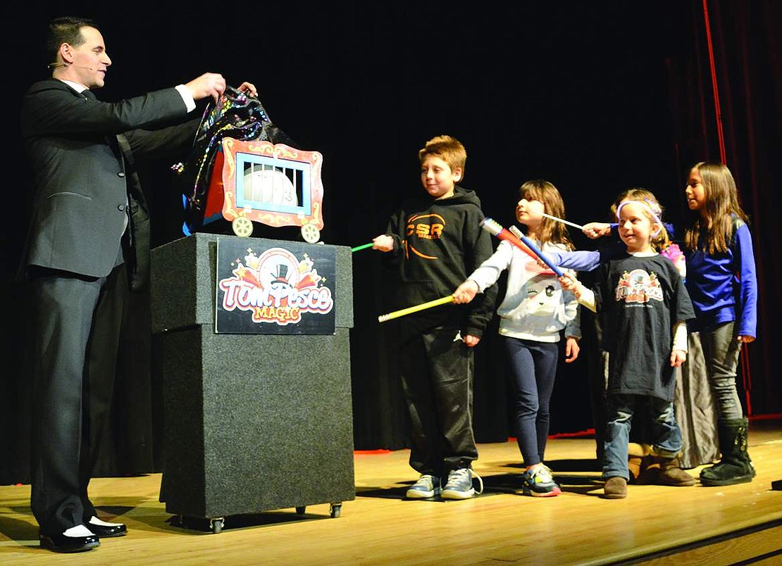  Children pulled from the audience wave magic wands in an effort to help magician Tom Pesce turn a balloon into a bunny. Tom Pesce, who is also a Blind Brook Middle School teacher, dazzled students and parents during a fundraiser for the Blind Brook PTA in the high school auditorium on Friday, Feb. 27. 