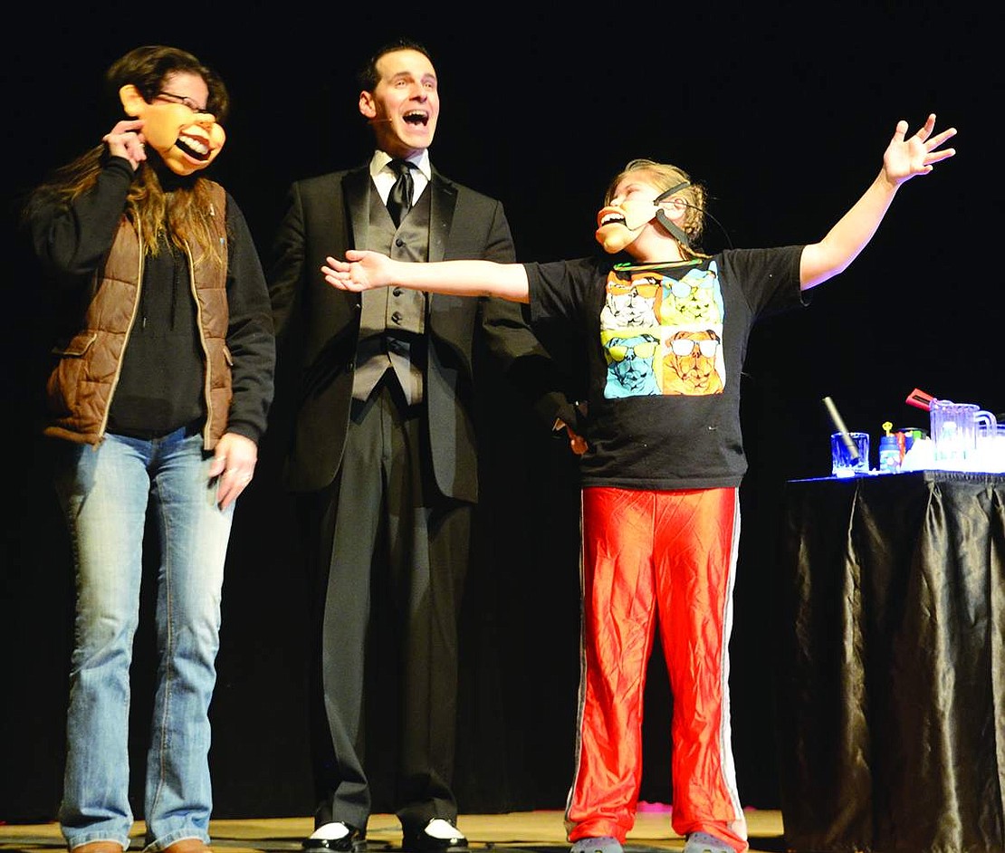  Using ventriloquist masks, magician Tom Pesce makes Bella Greaige (left) and her daughter Haley sing on stage. 