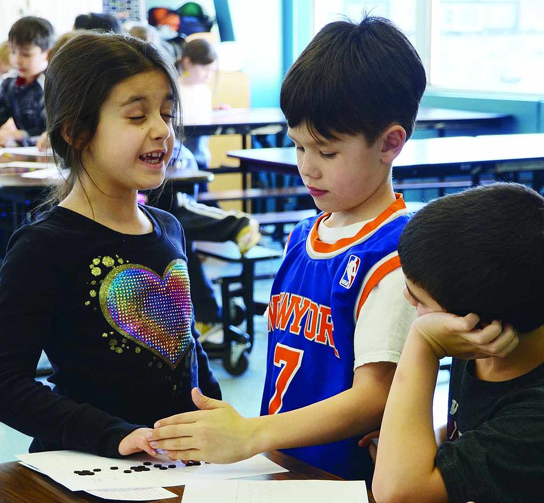  With her eyes closed tight, Isabella Montesano carefully reads each braille letter while Sebastian Lim and Tyler Taerstein, all first grade students in Maureen Jackson's class, check to see if she is correct. As part of the weeklong Creating Connections program, students at Ridge Street School spent time on Thursday, Mar. 19 doing hands-on activities to drive home the point of respecting fellow students and others with physical, sensory or developmental disabilities.