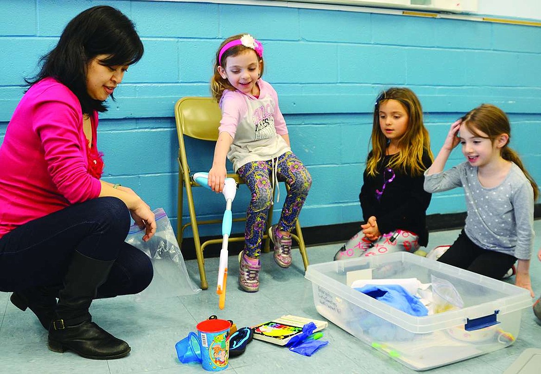  Marissa Hamlet (left) tries to grab objects using a picker-upper Marissa Hamlet tries to grab objects using a picker-upper tool as Dan Zhu (left) and fellow kindergartners from Stephanie Taylor's class, Sara Levine and Holly O'Neill, watch. 