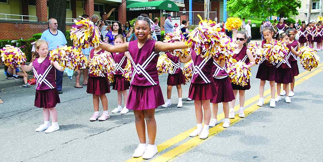 Toni Ash, a second grader from King Street School, shakes her pompoms. 