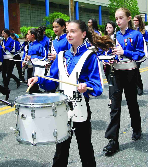 Port Chester Middle School 6th grader Eva Quartarolo keeps the beat while marching down the avenue.  