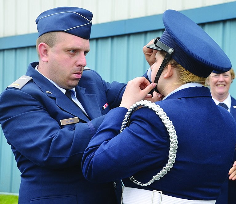  At Westchester County Airport, Civil Air Patrol 2nd Lt. Anthony Alfano fixes the cap on his niece, Cadet Airman Autumn-Lynne Aarons. 