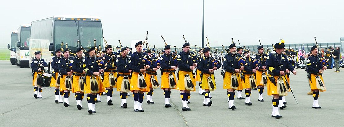  The Pipes and Drums of the Police Emerald Society of Westchester lead the way into the airport hangar for the buses full of veterans ready to fly to Washington, D.C. 