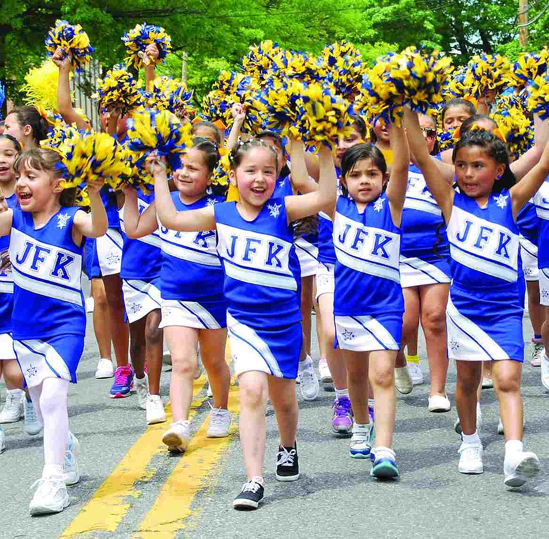 Kindergartner Felicia Urigea, surrounded by her fellow John F. Kennedy School classmates, chants "JFK" as she walks. 