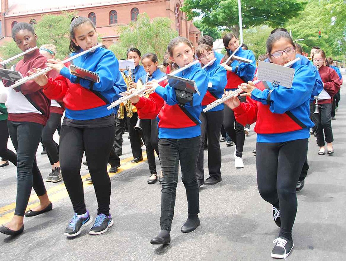 Dressed in red and blue for Park Avenue School, fifth graders Ester Magana (left), Rylie Heffernan and Michelle Salazar play flutes in the Port Chester Elementary Parade Band.