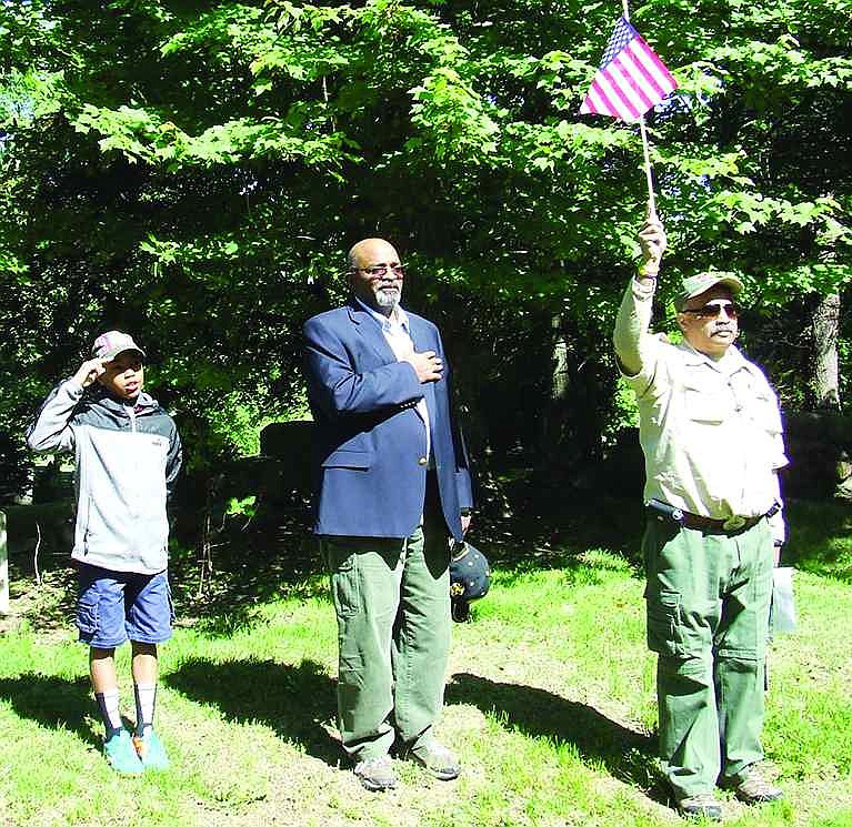 Port Chester residents lead the Pledge of Allegiance during a Memorial Day ceremony on Saturday, May 23 at the Town of Rye's African American Cemetery next to Greenwood Union Cemetery in Rye. From left: Jeremy Taylor, a Cub Scout from Pack 19, Dave Thomas, a Town of Rye employee and emcee of Saturday's ceremony, and Boy Scout Troop Leader Moe Acevedo. 