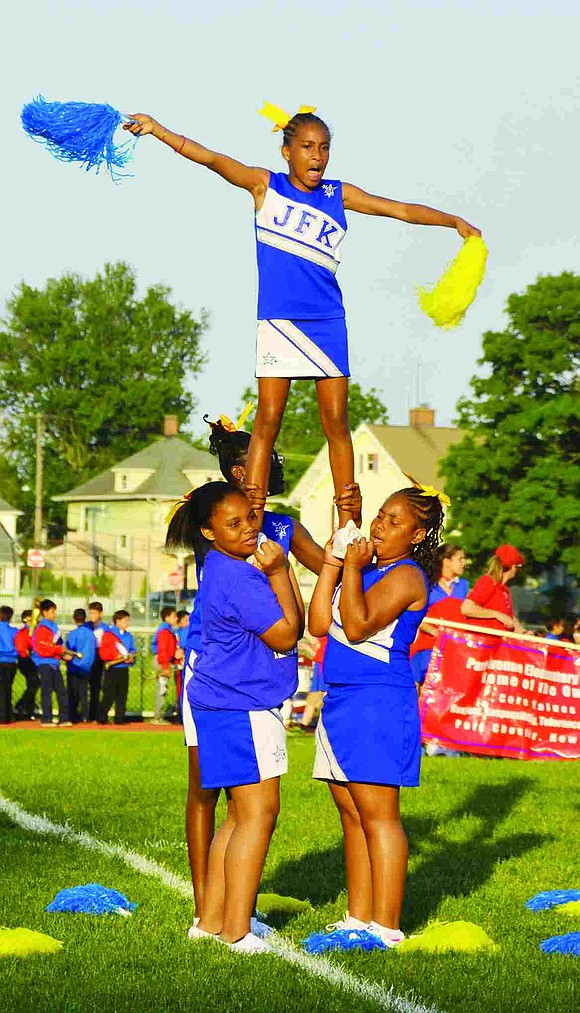 From  John F. Kennedy School, Nalah Jones shakes her pompoms while supported by Taylor Martin, Gabby Strachan and Khaliah Thomas 