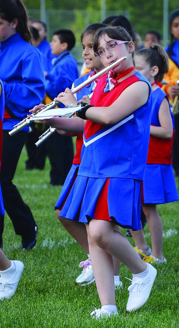 As part of the Port Chester Elementary Parade Band , Gwen Dominguez, a 4th grader at Park Avenue School, plays the flute. 