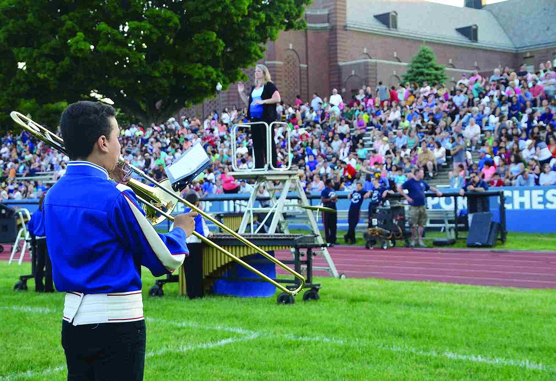 Brandon Molano, a 6th grader, plays the trombone to packed stands at Port Chester High School's Ryan Stadium for the 71st annual Band Night on Tuesday, May 26.  