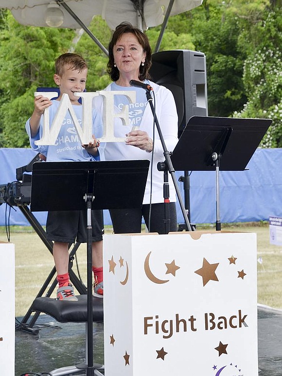 Ridge Street School first grader Jack Pastor and his teacher Linda Greco speak about the importance of working together and changing the mentality of "ME" to "WE." Both cancer survivors, Pastor and Greco, spoke during the opening ceremony. 