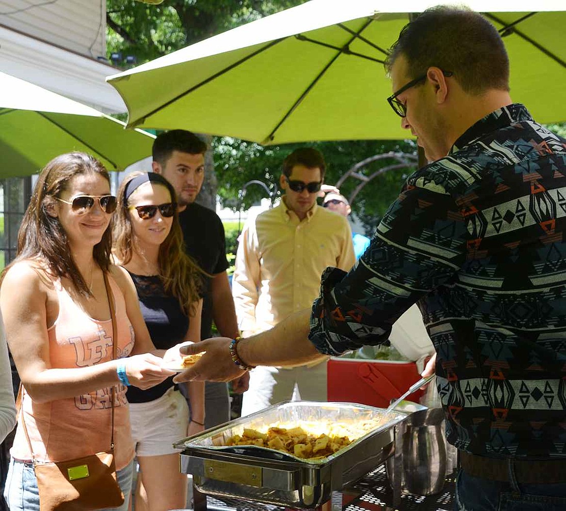  Mario Salov (right), the floor manager at nessa, hands out some of the restaurant's rigatoni Bolognese to Nicole Hanrahan (left) of Stamford, Conn. and Rebecca Barrett of Port Chester. 