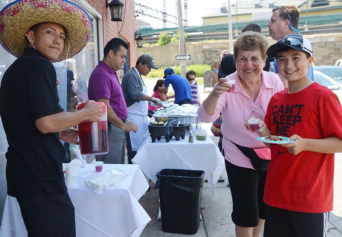  Joan Conklin of Rye Brook and her grandson Andrew Conklin of Fairfield, Conn. sample the food and drinks from Salsa Picante. Joan organized the first Taste of Port Chester to benefit Tamarack Tower Foundation in 2011 and her grandson has made sure not to miss a single one. 