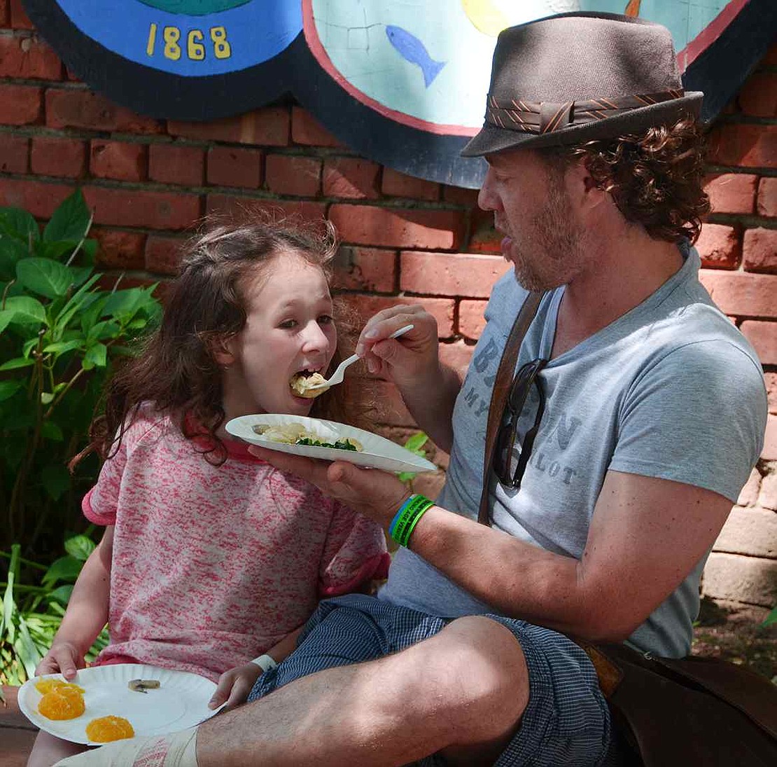  Eight-year-old Tessa Feinbloom tries some of the food her father Jeffrey got from Copacabana Steakhouse. The Feinblooms live in Mamaroneck, but Jeffrey works as an immigration attorney in Port Chester. 