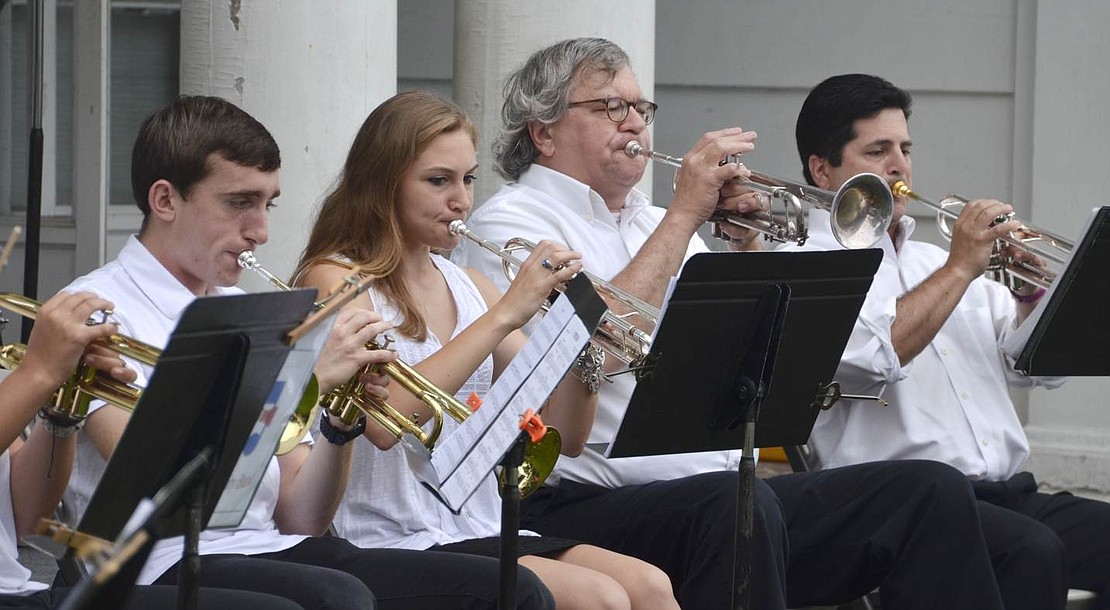 Members of the Rye Town Community Band, Lukas Patrizio (left), Brooke Pietrafesa, Mark Kamensky and Rob Sachs, play trumpet during a rendition of "Yesterday" by John Lennon and Paul McCartney. 
