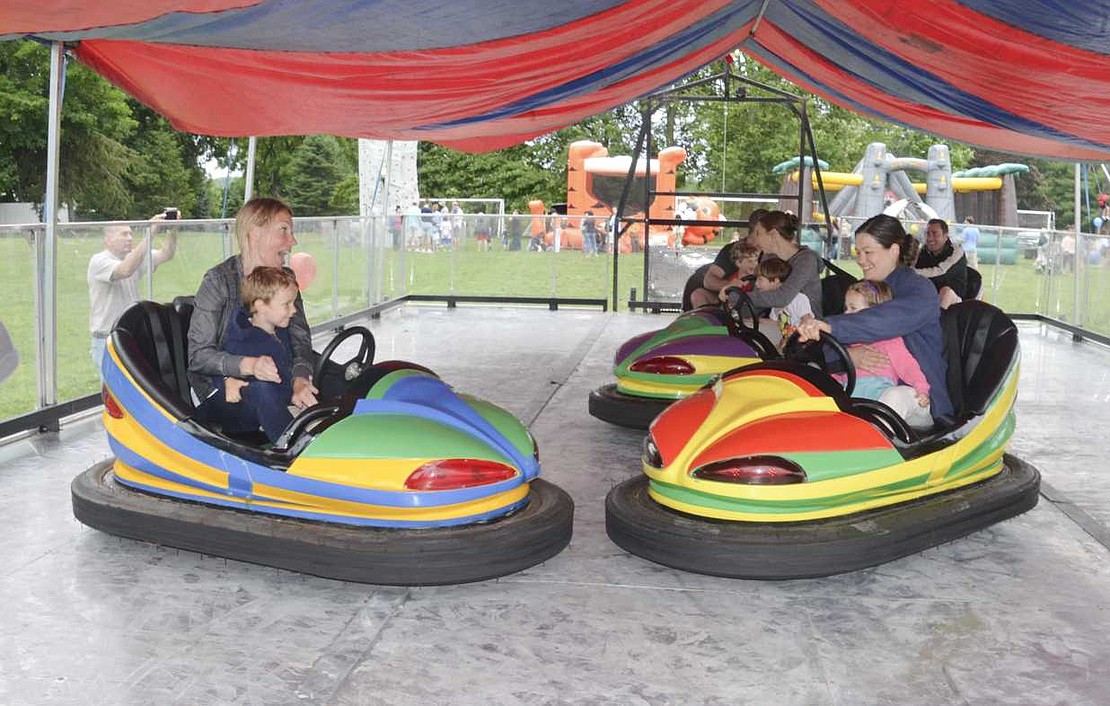 Two Rye Brook mothers, children seated firmly on their laps, go head to head during an intense round of bumper cars. From left, Karit Albanese, Nicco Albanese, 3, Melissa Miller, and Sage Miller, 2. 