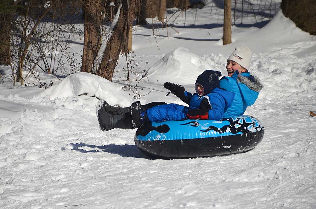 Natalie and Sasha Panitkin, ages 11 and 3, of Maple Court have a ball tubing down the Crawford Park hill.