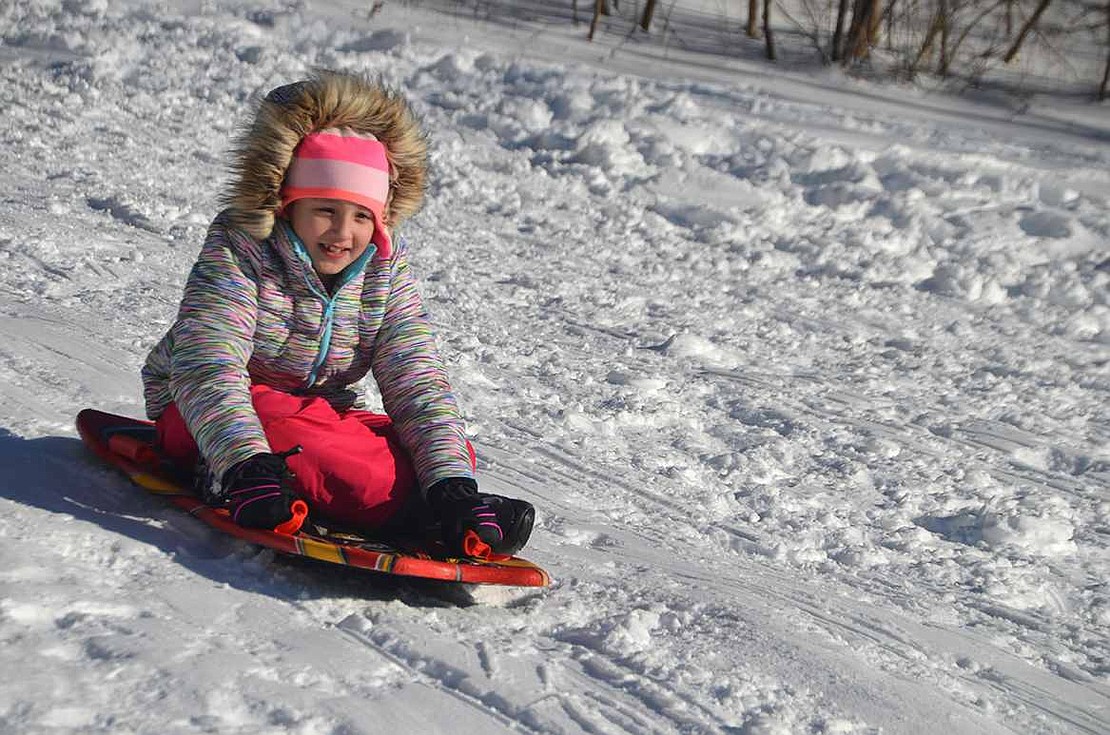 Anine Breen, 8, of Port Chester, slides down the more gradual hill on the Lincoln Avenue side of Crawford Park on the day after the first snowstorm of the season on Saturday, Jan. 23.