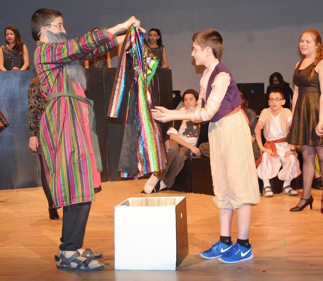  Jacob, played by Abe Baker-Butler, presents a dazzling coat of many colors to his favorite son Joseph, played by fellow Blind Brook 8th grader Wyatt Steinthal.