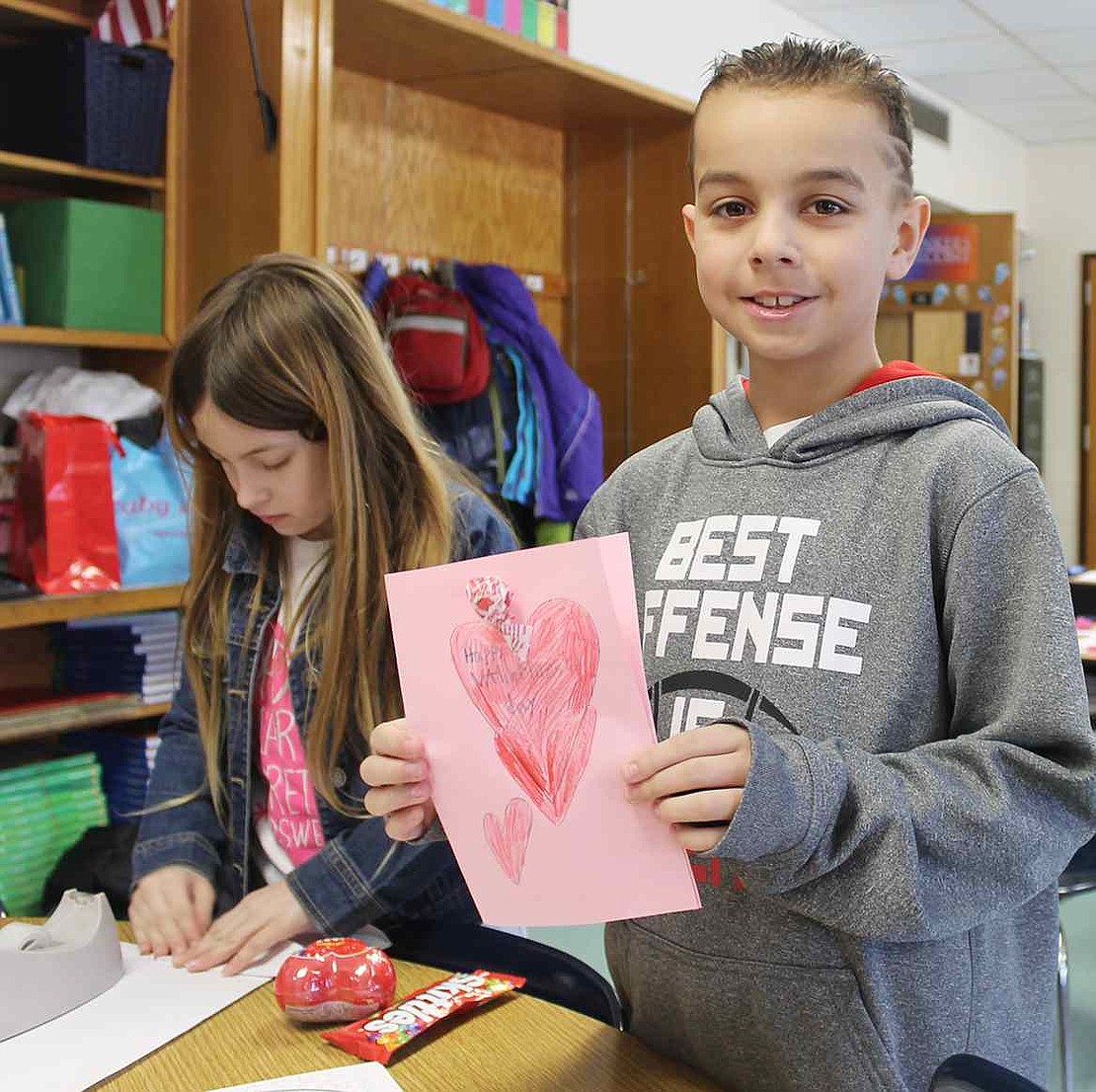  Ridge Street School fourth grader Connor Nethercott holds up the card he made. 