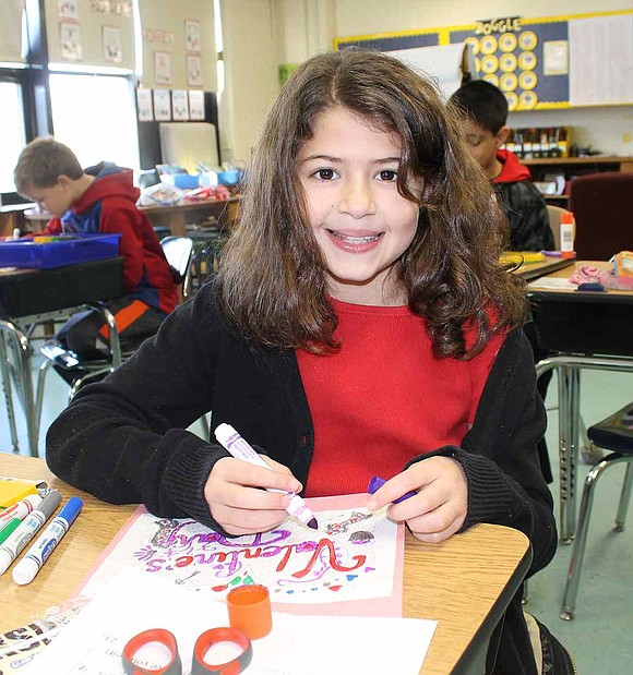  Sophia Lott, a fourth grader, colors in the valentine she made. For Valentine's Day, Ridge Street School's fourth graders created cards for children from homeless and economically disadvantaged families. 