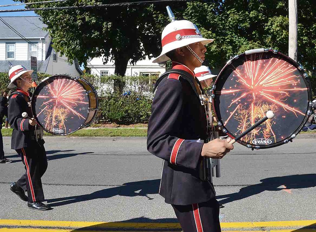 Port Chester High School Band drummers march down Westchester Avenue.