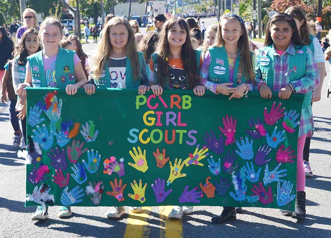 The Port Chester-Rye Brook Girl Scouts carry one of the many group banners in the parade. 