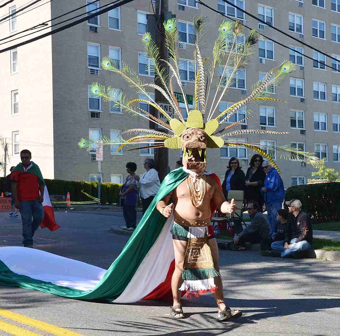 Dressed in an elaborate Aztec costume, Juan Elizalole of Yonkers strides proudly down the street.  